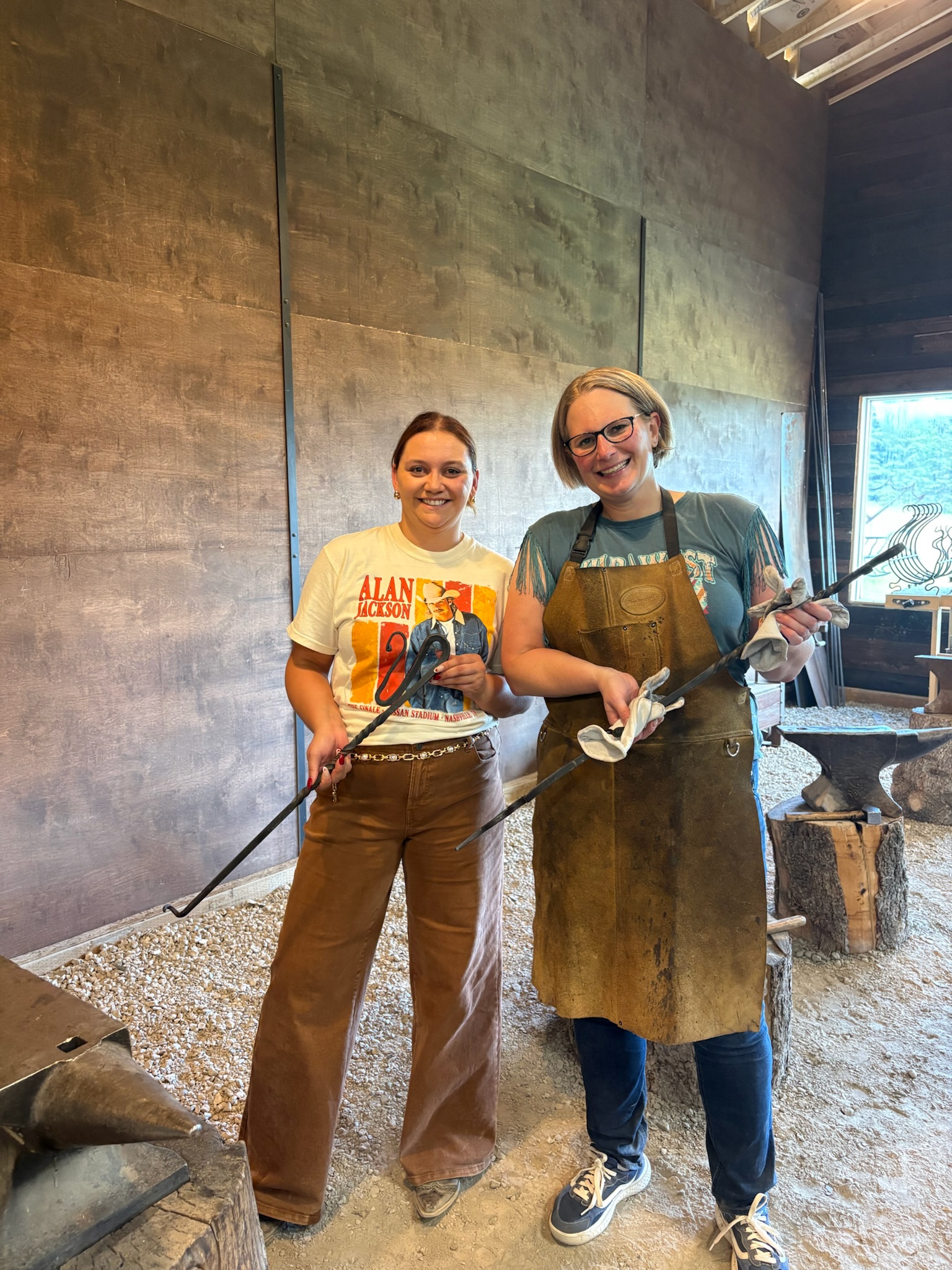 Two guests holding the pieces they forged