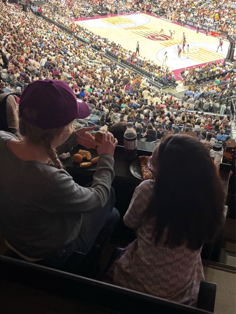 A parent and child watching the Toronto Tempo play the Indiana Fever